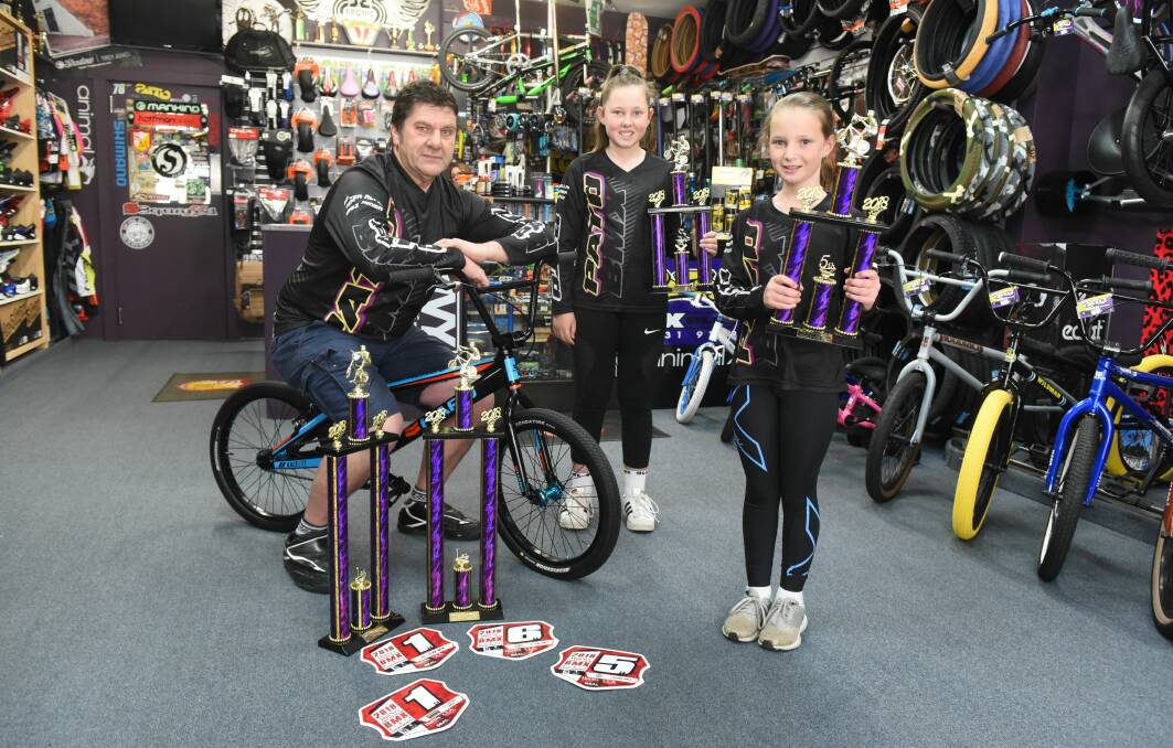 BMX BLITZ: Westbury's Patrick O'Callaghan and daughters Hayley, 12, and Sarah, 9, show off their trophies. Picture: Paul Scambler