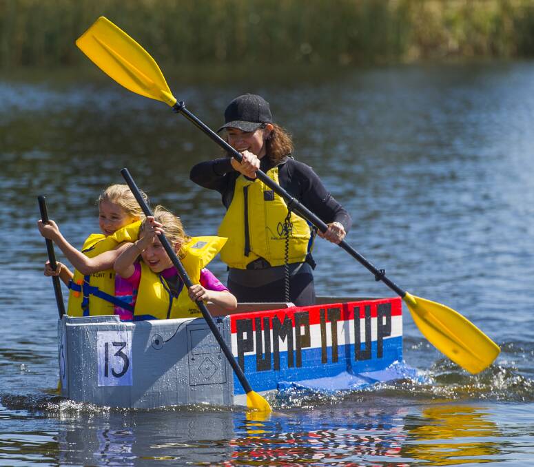 OARS OUT: Katy Dyson looks after the stern as Layla, 9, and Liv Dyson-Oliver, 7, help push Pump It Up along to victory in the family race at the Soggy Bottom Cardboard Box Boat Regatta at Waverley Lake Park. Picture: Scott Gelston
