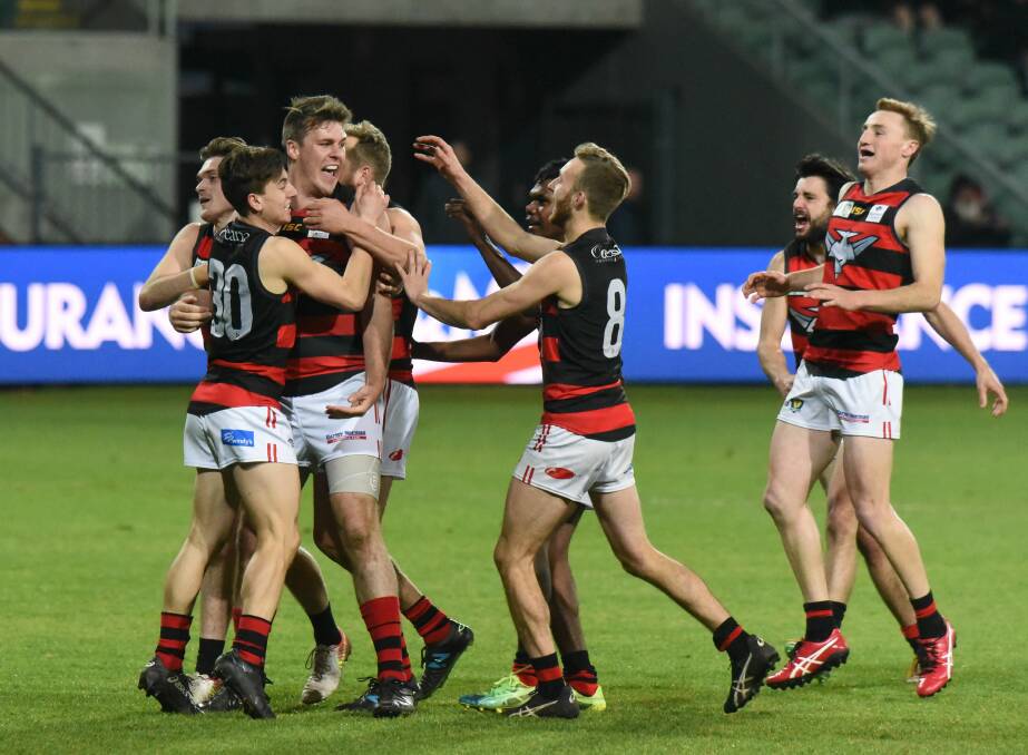 BOMBER BOUNCE: Lauderdale ruckman Haydn Smith celebrates a goal with teammates. 