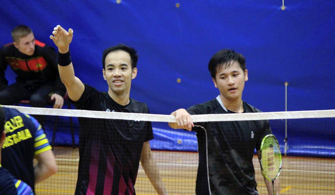 NET GAINS: Tran Hoang Pham and Ming Lim shake hands with their opponents after winning a three-set men's doubles final on the last day of the national badminton championships at Elphin. Picture: Hamish Geale 