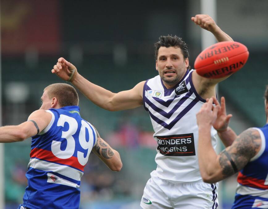 HIGH-FLIER: Former Melbourne forward Russell Robertson in action for Burnie in 2013. The 37-year-old will join ex-Magpie Brodie Holland in pulling on the black and green for Scottsdale's clash with Winnaleah on Saturday. 