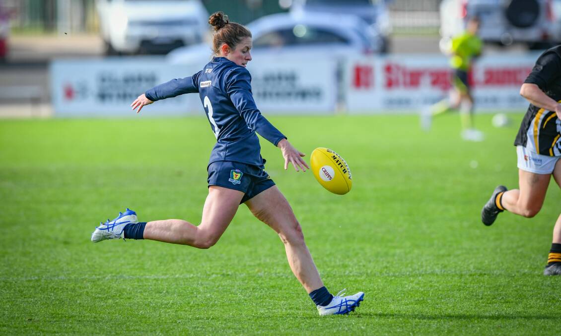 LOAD-UP: Angela Dickson kicks upfield in the Blues' win over Kingborough. Picture: Paul Scambler 