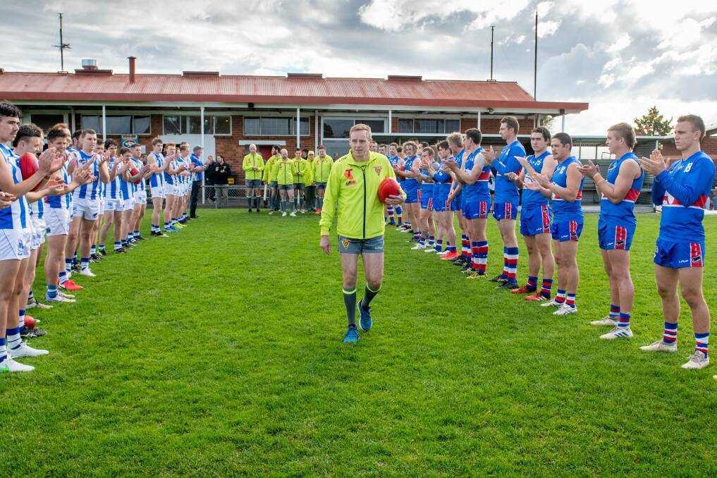 NICE GARRY: Veteran field umpire Garry Kaine is welcomed onto the ground by Deloraine and South Launceston ahead of his 700th game. Picture: Paul Scambler