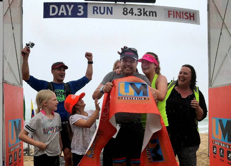 TEAM EFFORT: Matt Wheatley celebrates with his family after finishing the Ultraman Australia in Noosa. Picture: Supplied