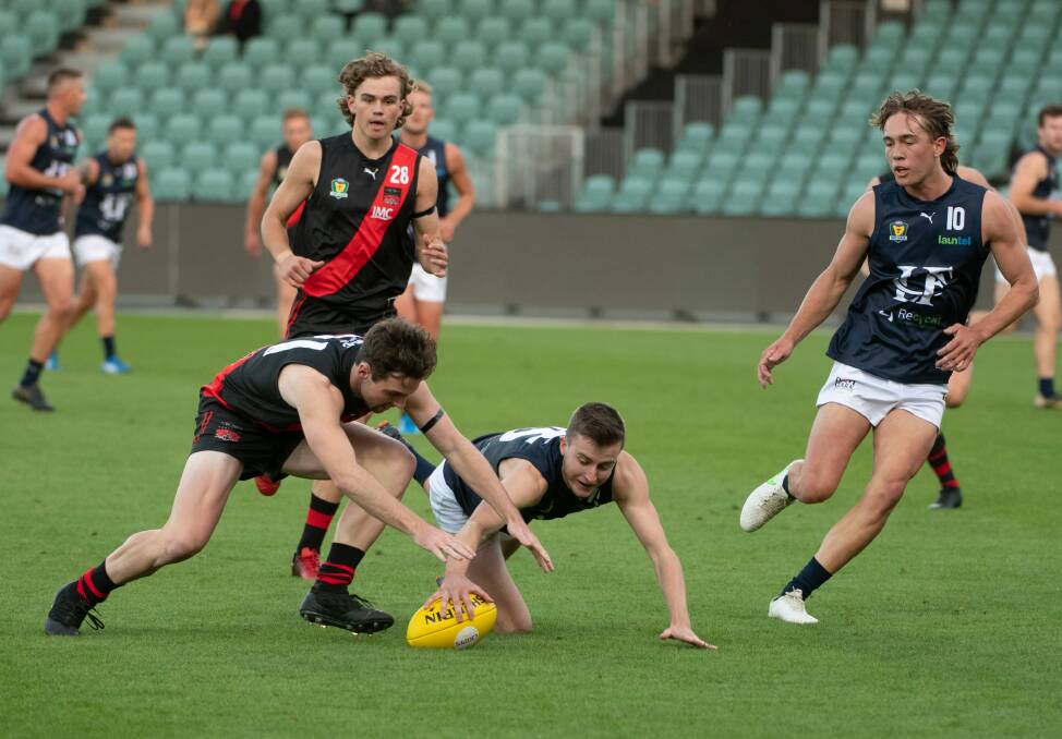 Northern Bombers pair Ryan Whitney and Harry Bayles around the footy. 