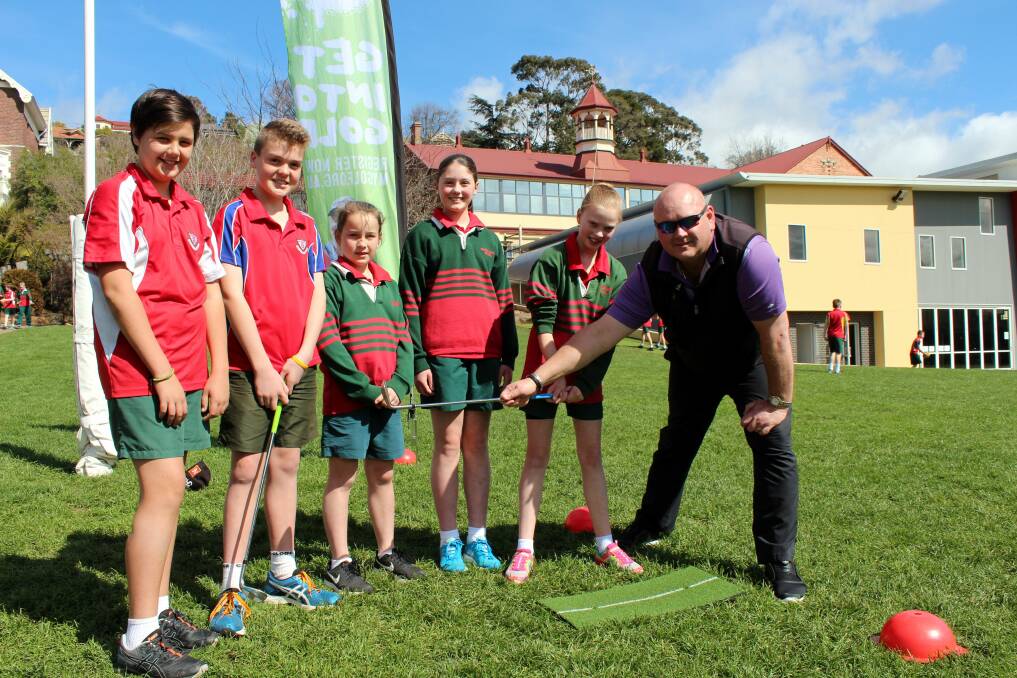 CHIPPING AWAY: Sacred Heart students Kane Russell, Jett Hill, Torie Mansell, Molly Tanton and Zoe Gillow take some tips off Mowbray Golf Club professional Brent Barlow. Picture: Hamish Geale 