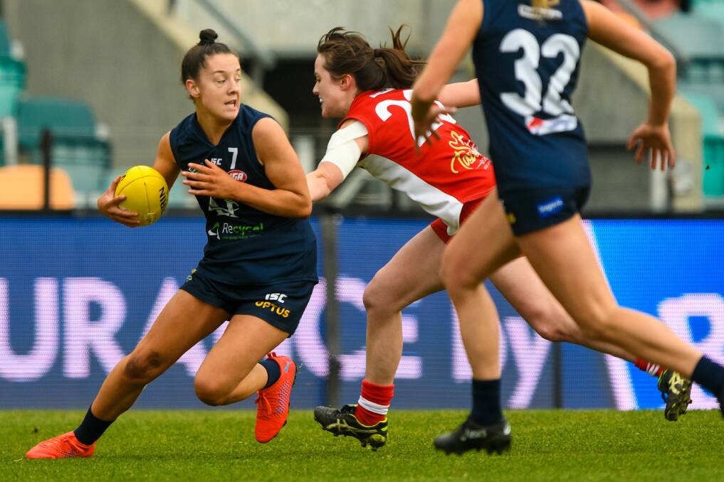 ROO AND BLUE: Launceston's AFLW star Chloe Haines evades a Clarence opponent in the TSLW grand final. Picture: Phillip Biggs