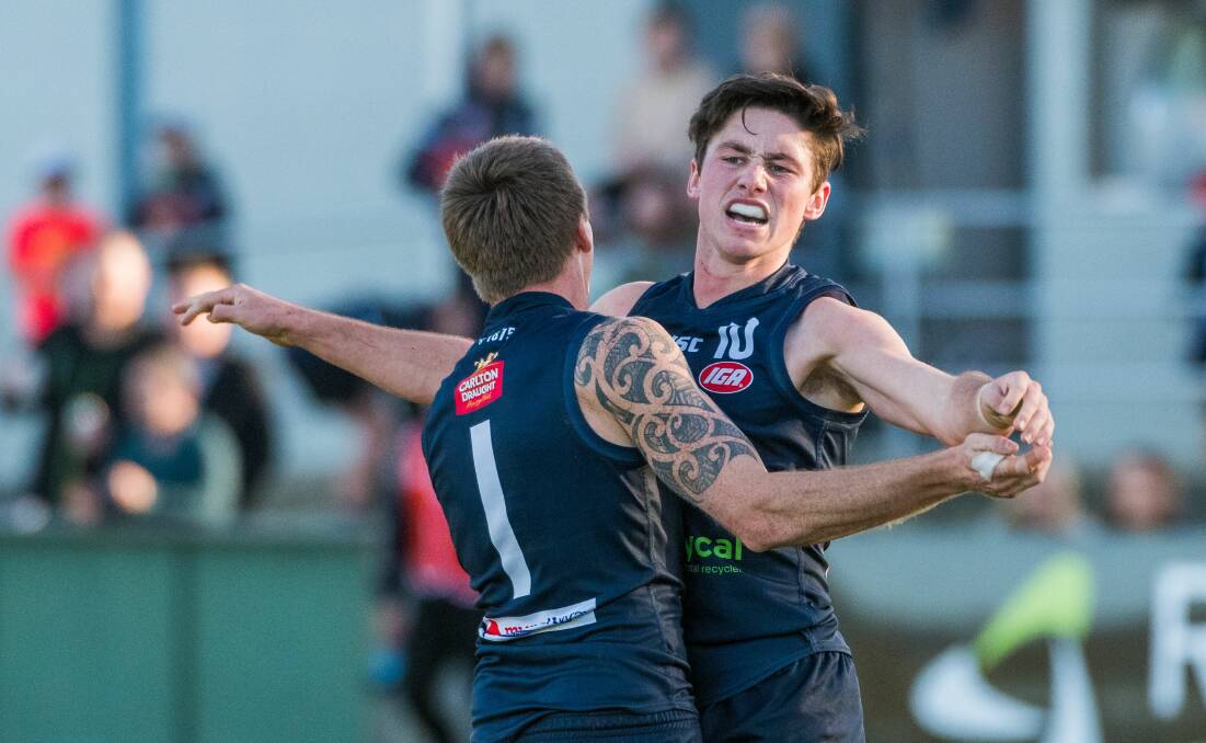 A fresh-faced Jones celebrates a goal with Launceston teammate Dylan Riley in 2018. 