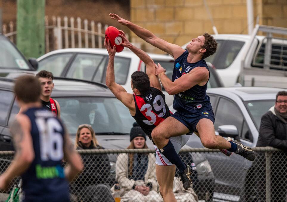 DUKES: Northern Bomber Arion Richter-Salter takes a strong grab under pressure from Launceston ruckman Tim Auckland. Picture: Phillip Biggs
