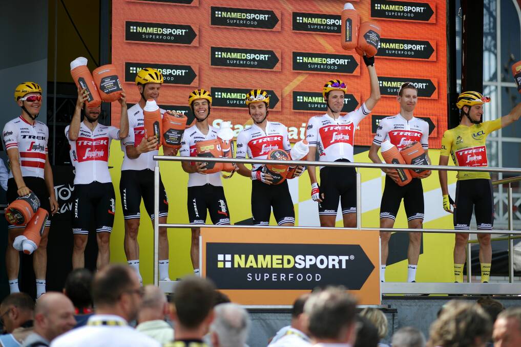 Standing tall: Richie Porte (fourth from left) and his teammates enjoy a rare Tour de France podium in 2019. Picture: Twitter