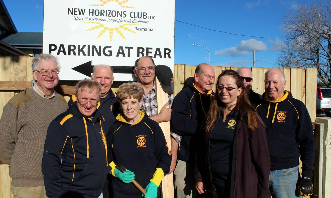TEAM EFFORT: Launceston and Central Launceston Rotary members gather to work on the fence at New Horizons. Pictures: Hamish Geale