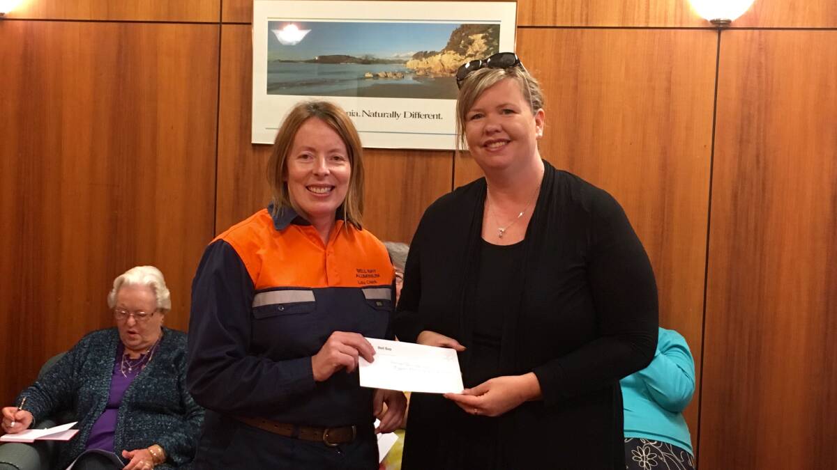 BANDING TOGETHER: Bell Bay Aluminium's Lou Clark presents George Town mayor Bridget Archer with a $500 donation towards Friday's Biggest Morning Tea. All funds raised will be donated to the Cancer Council. Picture: Supplied.
