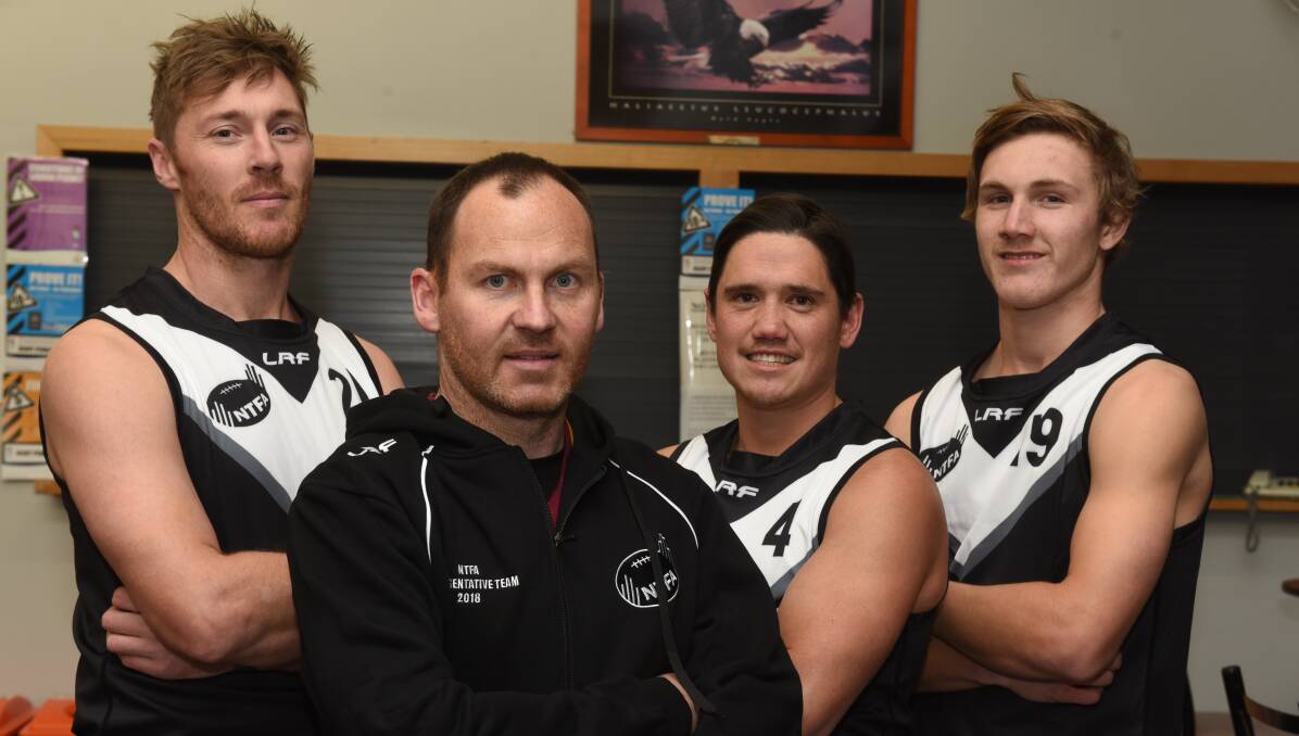 RARING TO GO: NTFA representative players Geoff Mohr, Leigh Harding and Brayden Claridge with coach Aaron Viney. Picture: Paul Scambler