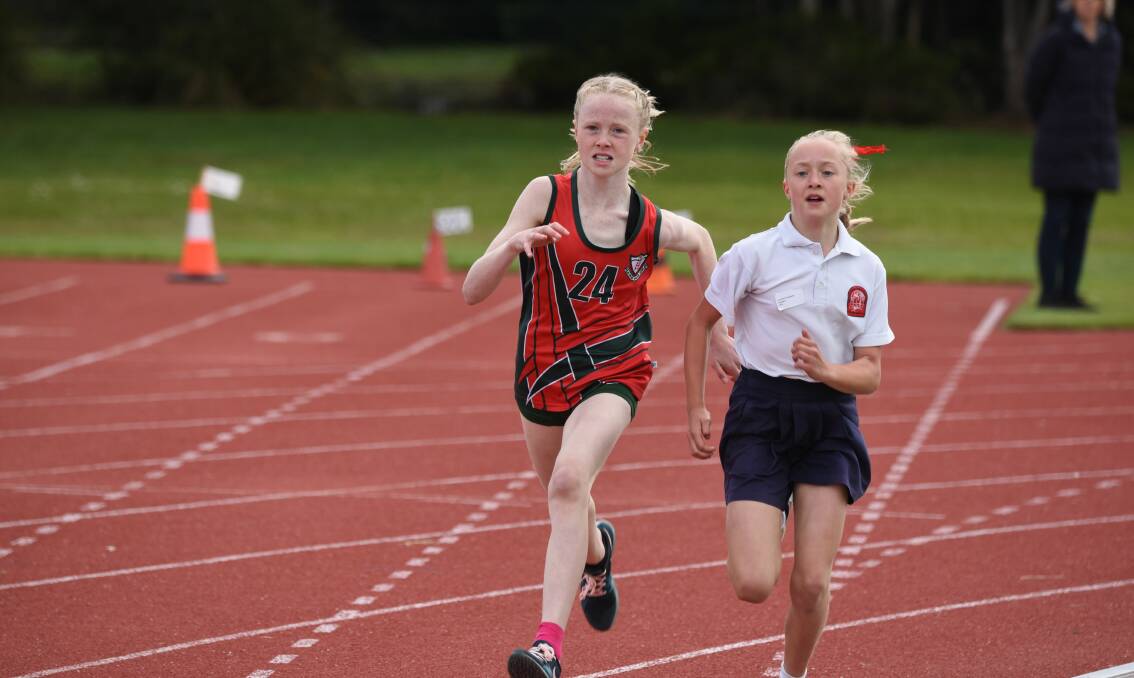 TIGHT TUSSLE: Sacred Heart's Ava Jones and Launceston Preparatory School's Lavinia Freeland go neck and neck in the grade 6 girls' 800 metres at the Northern Athletics Centre. Pictures: Paul Scambler