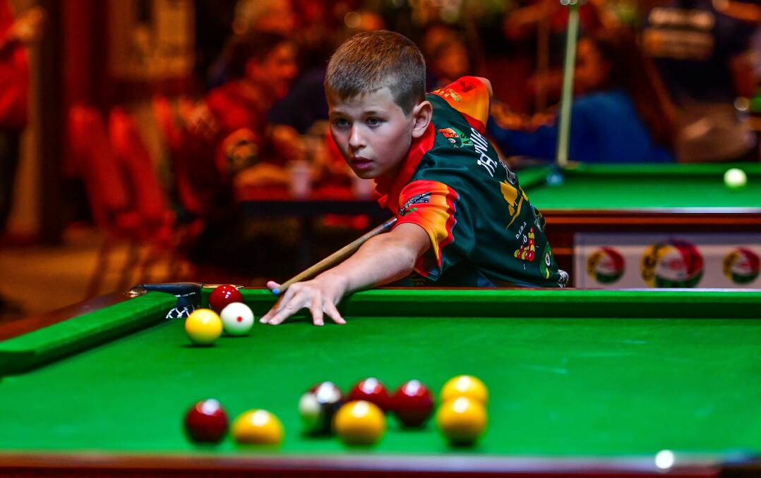 Tasmanian under-12 Blake Riley lines up the cue ball. 