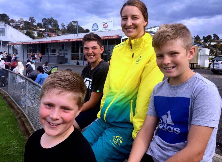 HIGH HOPES: Australian high jump champion Nicola McDermott at Windsor Park with Cooper Gleeson and Ciaran McRobbie, both of Trevallyn, and Wesley Bosker (front), of Launceston. Picture: Hamish Geale