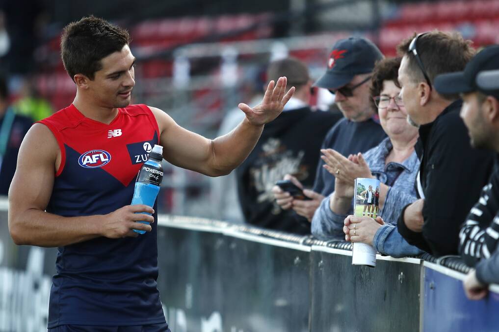 HIGH FIVE: Jay Lockhart celebrates with fans after a pre-season win. Picture: AFL Photos