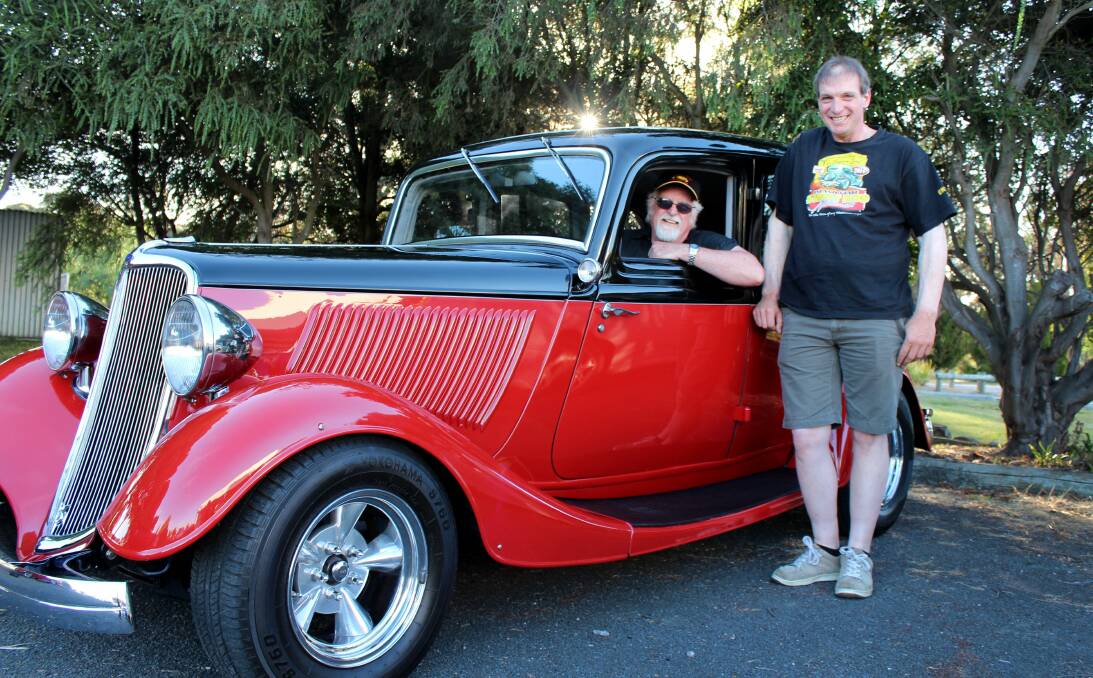 RED ROAR: Van Diemens Street Rod Club's Grant Sutton and Leigh Dennis show off a 1933 Ford sedan ahead of Sunday's show and shine at UTAS Stadium. Picture: Hamish Geale 