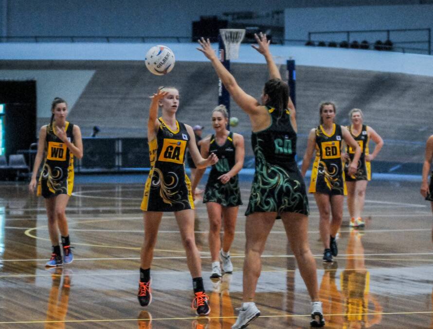 LOOK-AWAY PASS: Cavaliers goal attack Kate Gibson moves the ball up the court in her side's big win over Burnie. Gibson was named player of the match in the 70-24 thumping. Picture: Neil Richardson