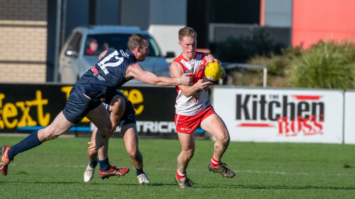 LET OFF: Clarence's Jack Preshaw gets a kick away in Saturday's loss to Launceston. 