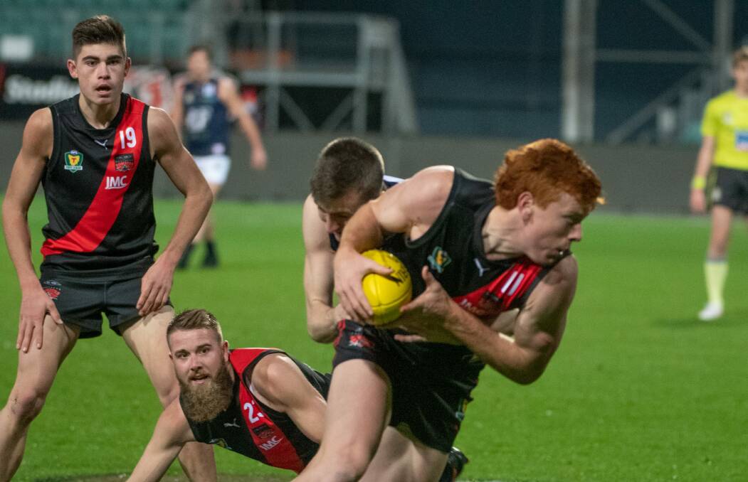 CONTESTED FOOTY: Northern Bomber Tom Donnelly breaks away as Declen Chugg and Nathan Pearce look on. Picture: Paul Scambler