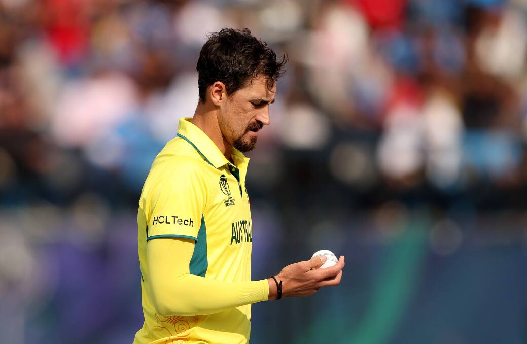 Mitchell Starc assesses the state of the ball in Australia's World Cup clash with New Zealand. Picture by Getty Images 