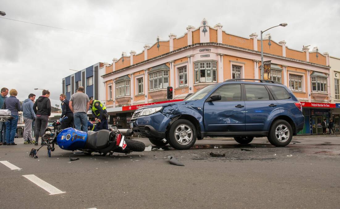 COLLISION: Police inspect the scene of a crash in Launceston on Sunday afternoon. 