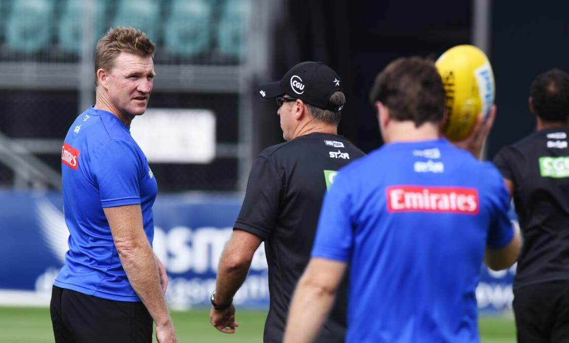 LINE CALL: A tennis game with Magpies assistant Brenton Sanderson and ex-world no. 8 Alicia Molik landed Nathan Buckley in hot water. 