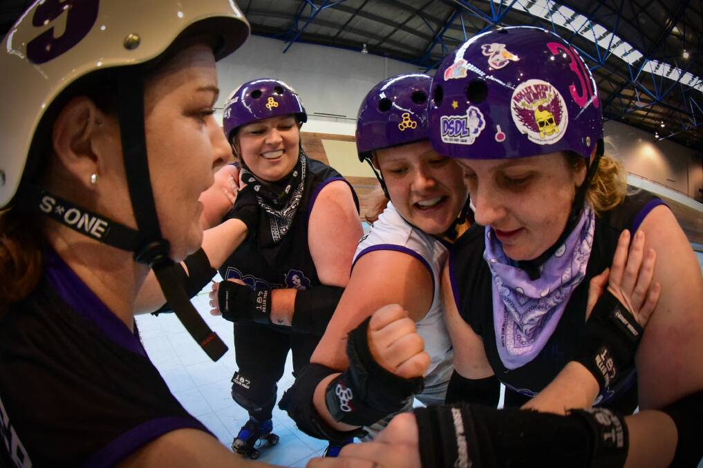 TIGHT-KNIT: Devil State Derby League's Anna Lohrey (Mad Katter), Emma Allen (SinDilemma), Sophie Clark (Dark Justice) and Erin Roberts (Breeder of the Pack) prepare for a clash with Inner West Derby League. Picture: Paul Scambler 