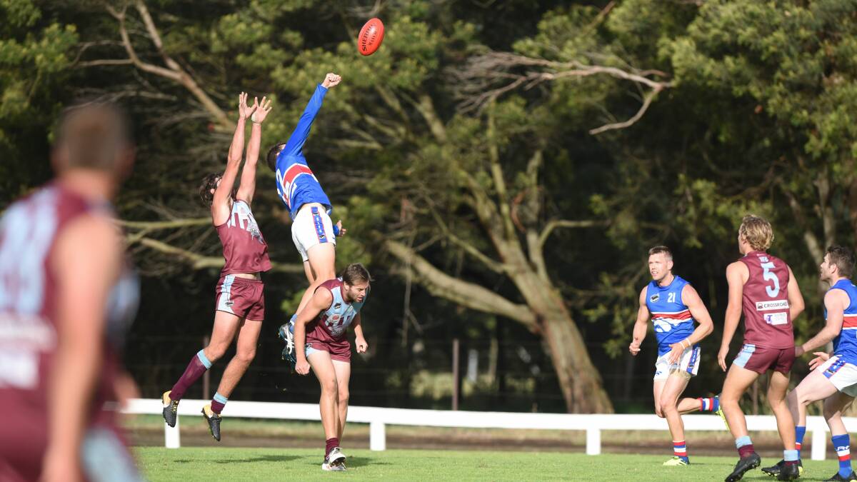 STAIRWAY TO DEFEND: South Launceston's Jack Maher uses Shaun Worker as a step-ladder to spoil the ball away from Jarrod Worker. Pictures: Paul Scambler.