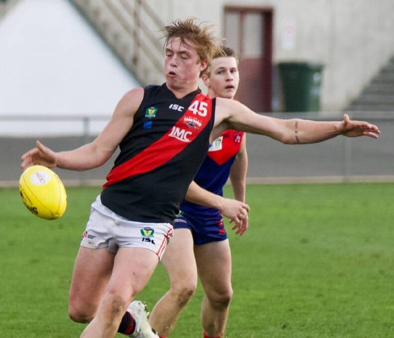 ON THE BURST: Lachie Cocker boots the ball forward in North's win over North Hobart. Pictures: Supplied