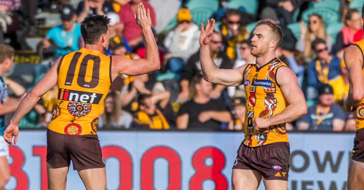 Tom Mitchell (right) shares a high-five with Jaeger O'Meara.