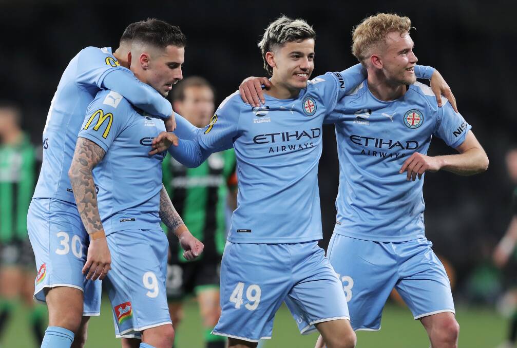 WE'VE DONE IT: Nathaniel Atkinson (right) celebrates with Jamie Maclaren and Stefan Colakovski following Wednesday's semi-final win over Western United. Picture: Getty Images
