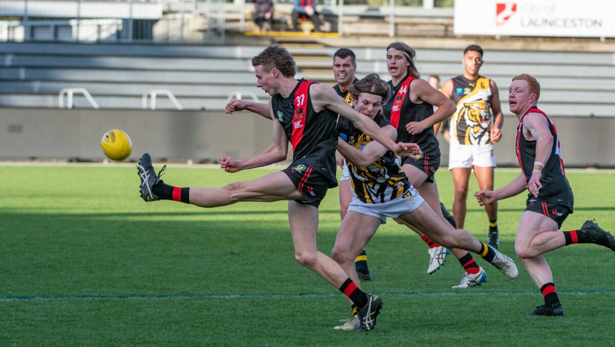 UNDER FIRE: North Launceston debutant Bailey Mitchell gets a kick away under pressure. Pictures: Paul Scambler