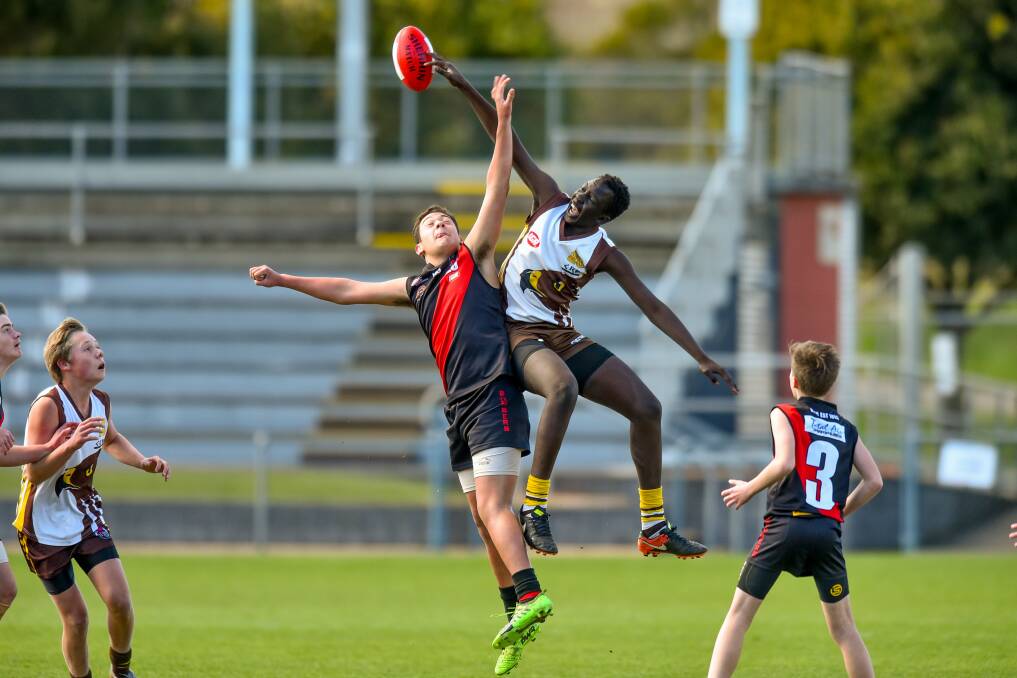 RUCK BATTLE: North's Poasi La'akulu and Prospect's Tony Aganas compete for the ball at UTAS Stadium during this year's NTJFA under-14 grand final. Both have been named in an extended squad for Sunday's development game. 