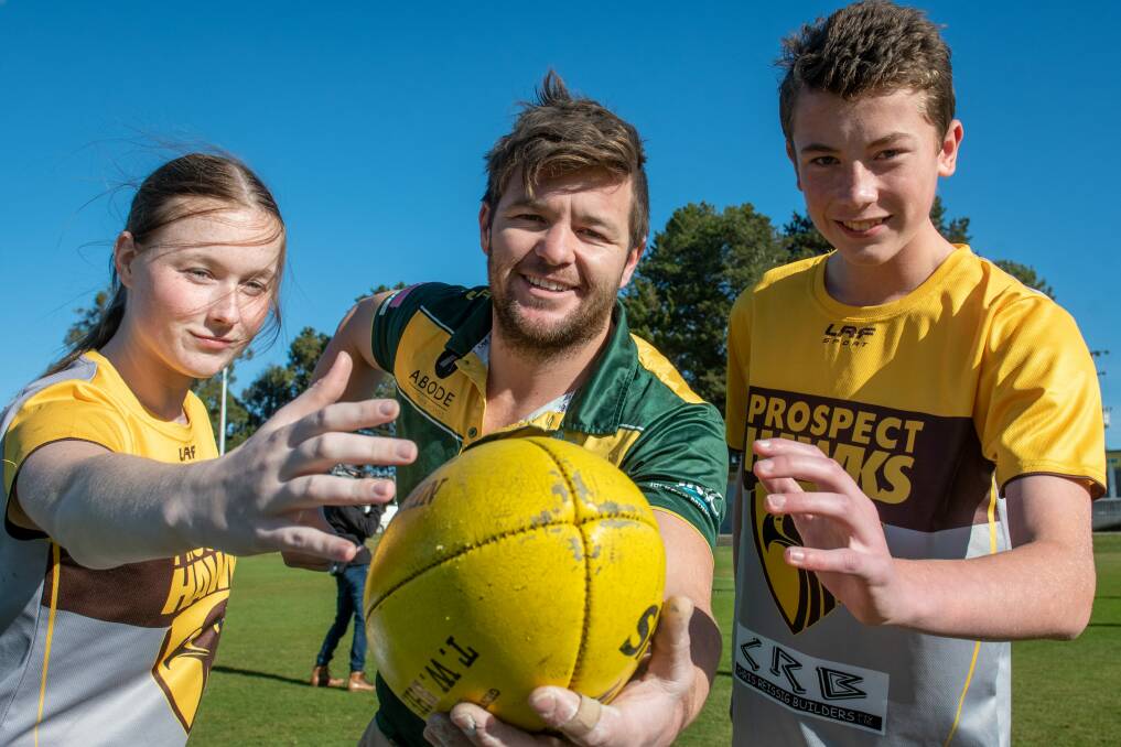 St Pats' Mathew Williams is flanked by Hawks Jade Graham and Isaac Smedley.