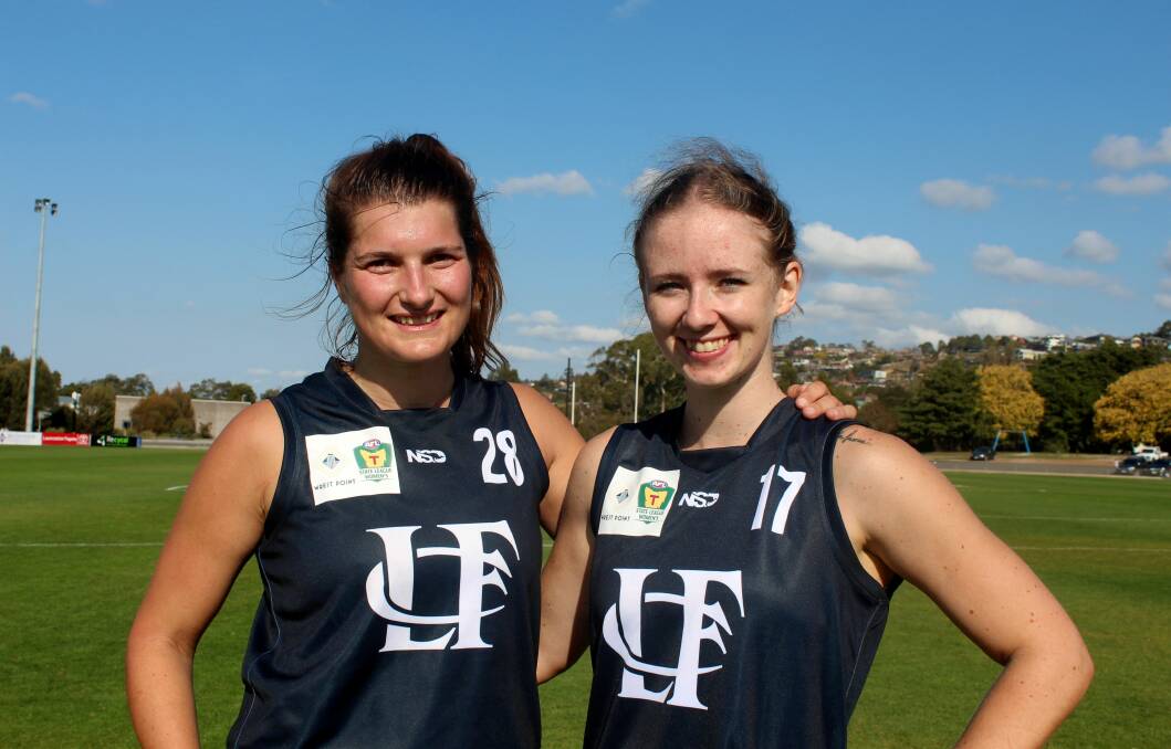 RIVALS IN ARMS: Launceston TSLW duo Kate McLaughlin and Zoe Claridge. The pair played State League netball on Saturday before lining up for the Blues on Sunday. Picture: Hamish Geale