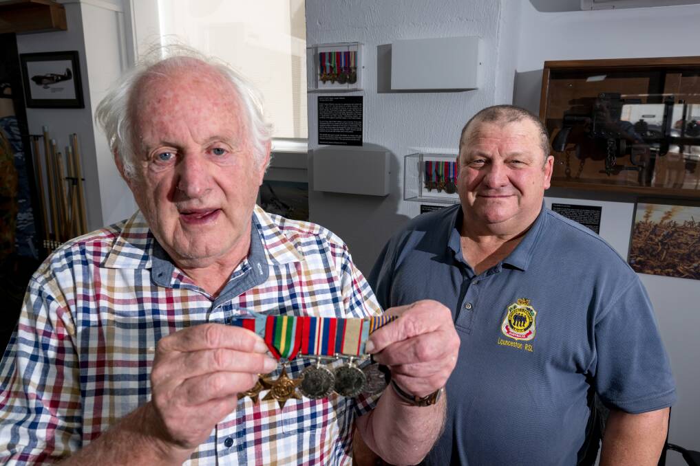 Michael Bayles presents his father Don's medals to Launceston RSL sub-branch secretary Peter Williams. Picture by Phillip Biggs