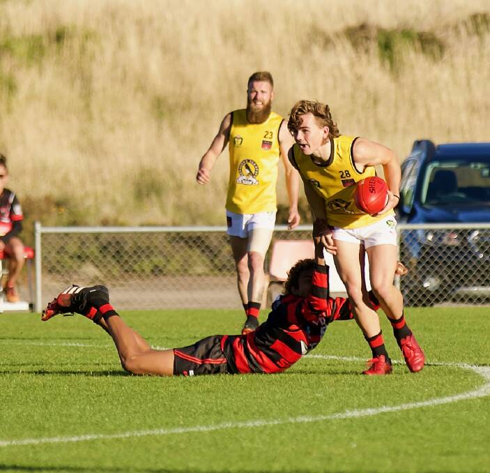 TOO SLICK: Harry Bayles shrugs off a would-be tackler in North Launceston's big win over Lauderdale. Pictures: Andrew Woodgate