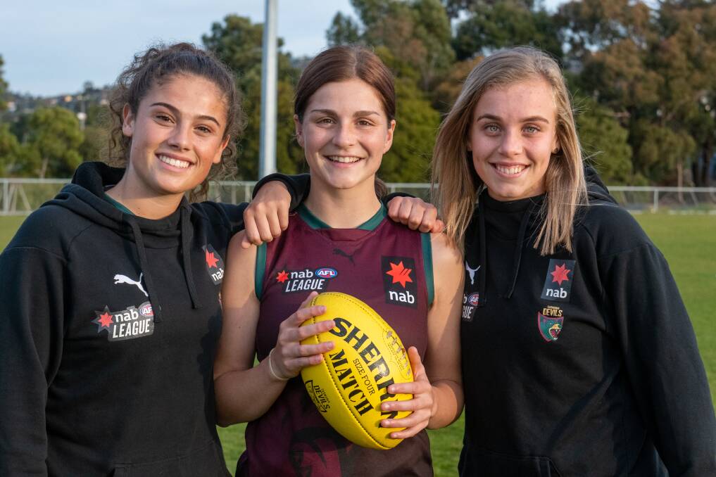 FINALS FEVER: Tassie Devils trio Maisie Edwards, Aprille Crooks and Jemma Blair at training ahead of Sunday's NAB League Girls final. Picture: Paul Scambler