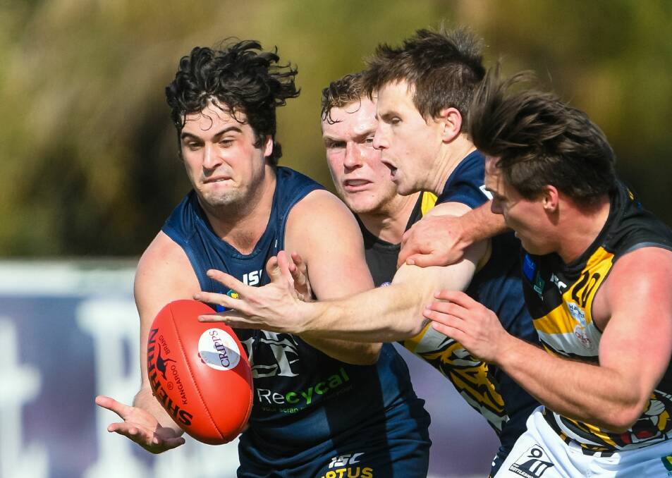 IN TIGHT: Blues tough nuts Fletcher Seymour and Brendan Taylor vie for possession with star Tiger Kieran Lovell. Picture: Phillip Biggs