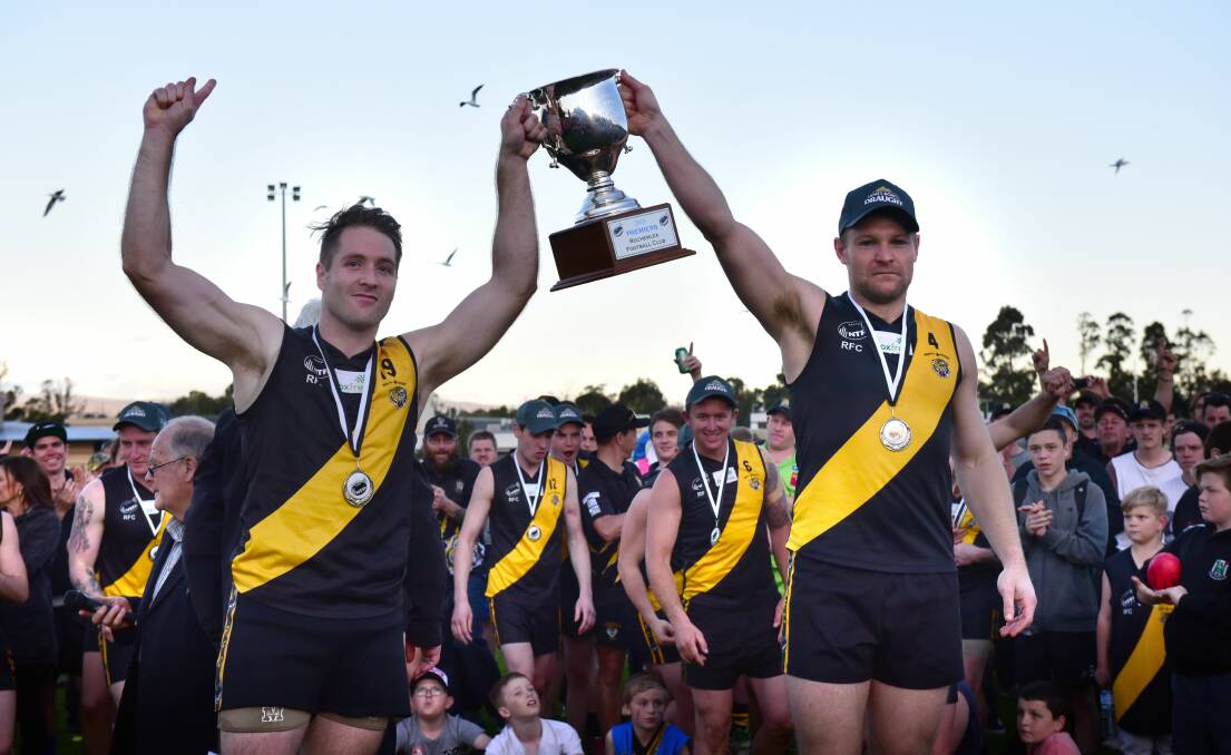 Stubbs (right) lifts the 2016 premiership cup with Brenton Gale. 