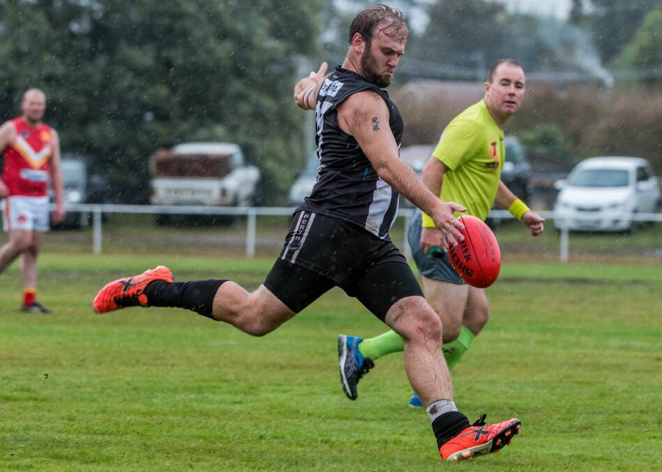 FULL STRIDE: Perth's Harley Thomas winds up in the wet.