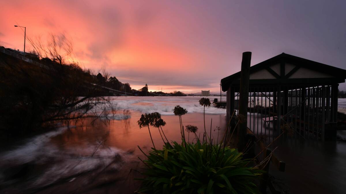An image of the Stelfox jetty and boathouse hours before it was washed away by floods. Picture by Scott Gelston 