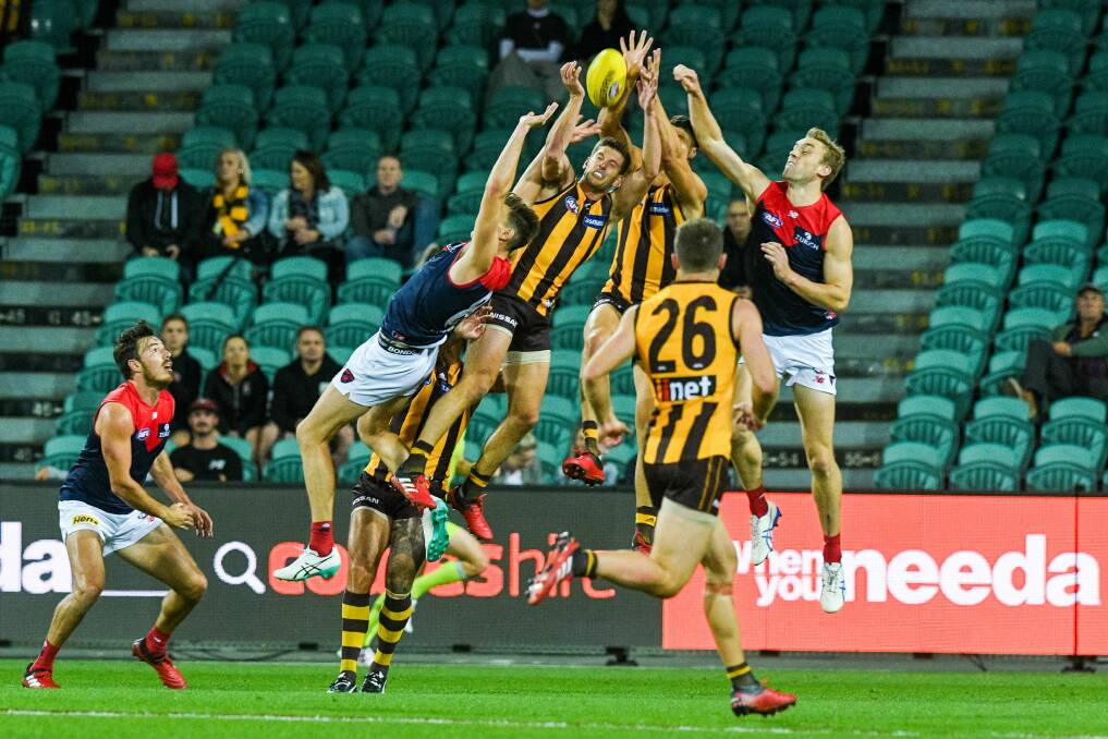 NOT SOCIALLY DISTANT: Hawthorn and Melbourne in battle at UTAS Stadium earlier this year before the coronavirus pandemic hit. 