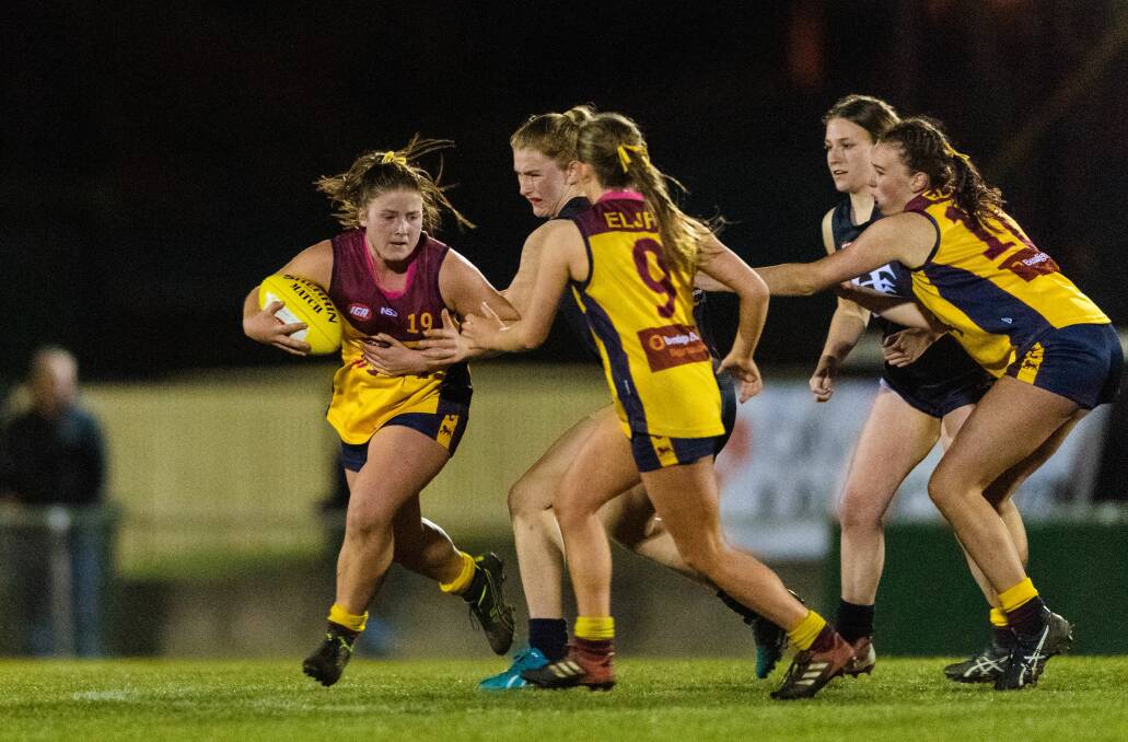 LION PRIDE: East Launceston's India Viney looks to break a Blues tackle during last year's under-17 girls grand final. Picture: Phillip Biggs