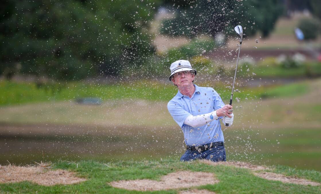 SAND STORM: Sydney's David Edwards chips onto the first green on the first day of the senior state championships. Pictures: Paul Scambler 