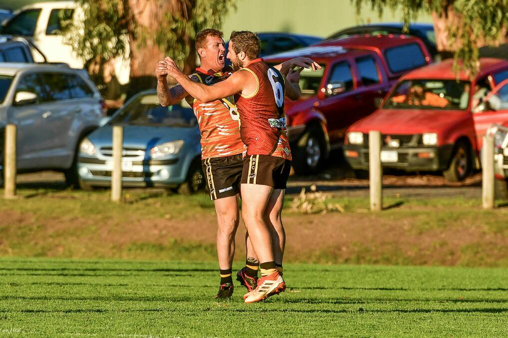LAP IT UP: Rocherlea coach Andrew Cox-Goodyer celebrates a goal with Jason Taylor in the Suburban Tigers' big win over George Town. Picture: Scott Gelston