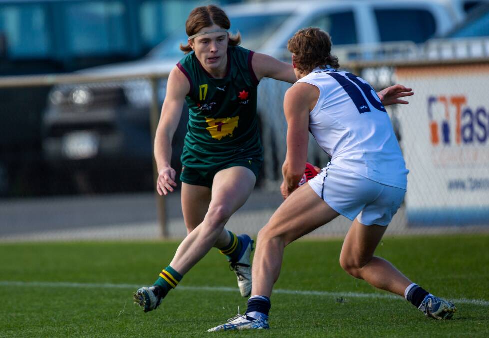 DRAGON ON THE LOOSE: Tassie Devil Bailey Gillow looks to round up a Sandringham opponent. Pictures: Solstice Digital