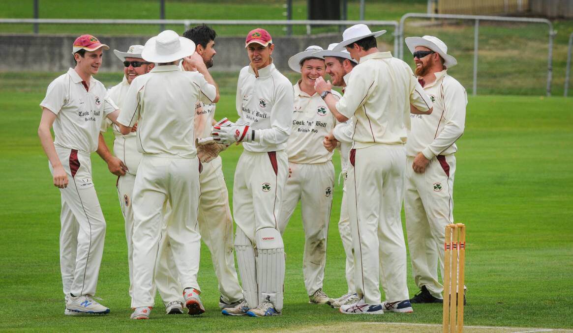 ALL IN: Players celebrate a wicket against Launceston. 